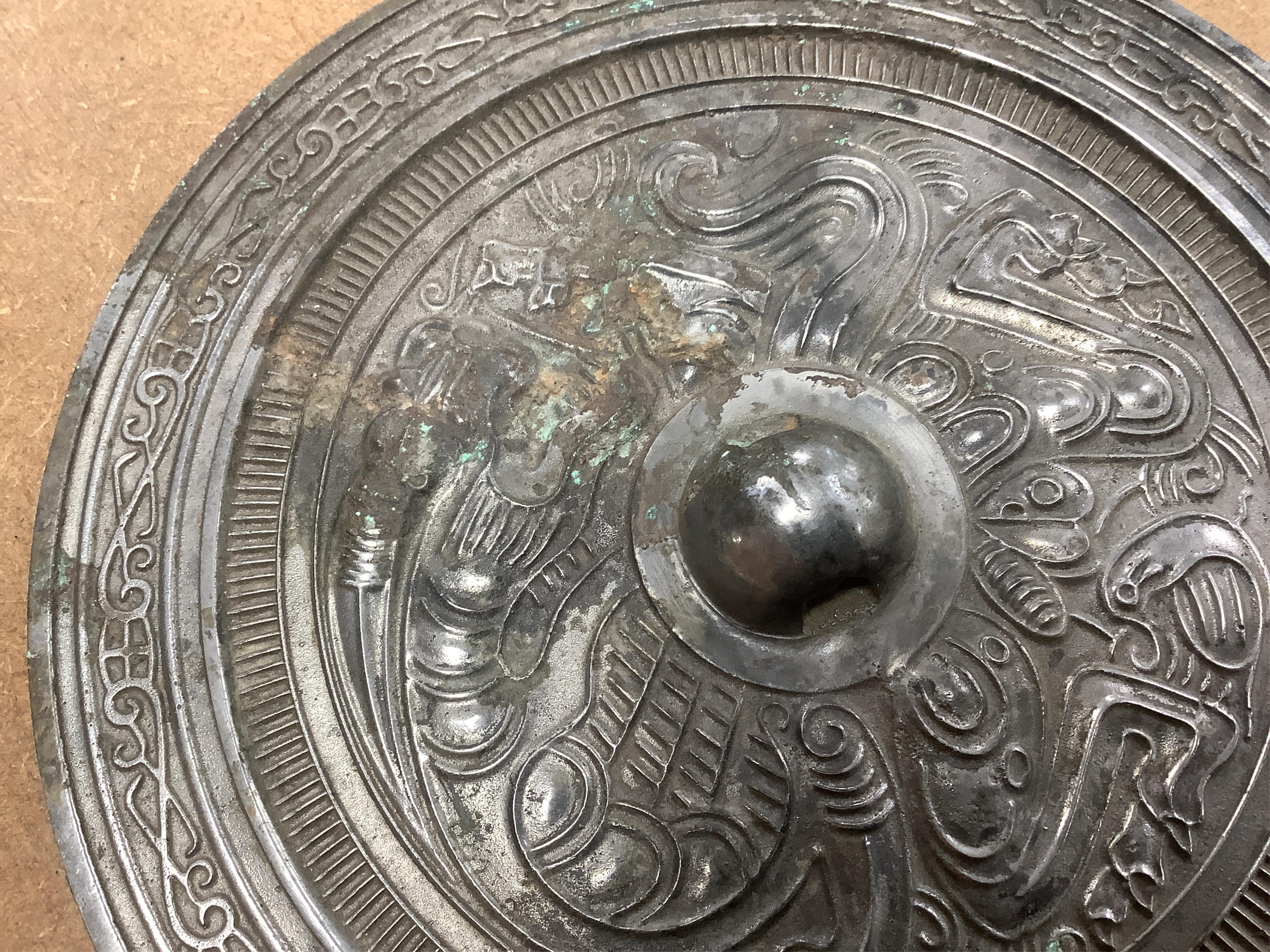 Chinese bronze ‘dragon’ mirror back, 19cm in diameter